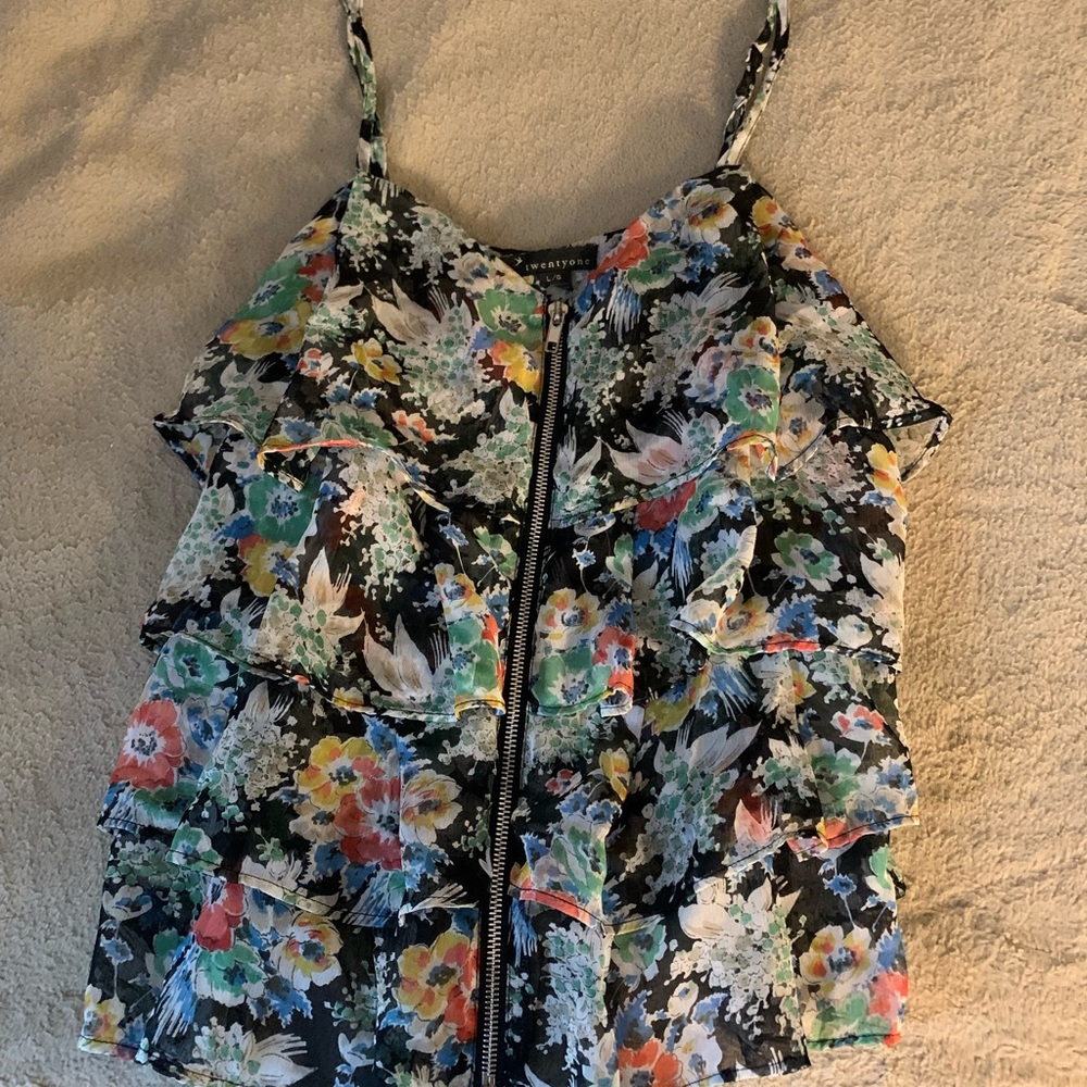 Multicolored floral blouse with zipper detail.
